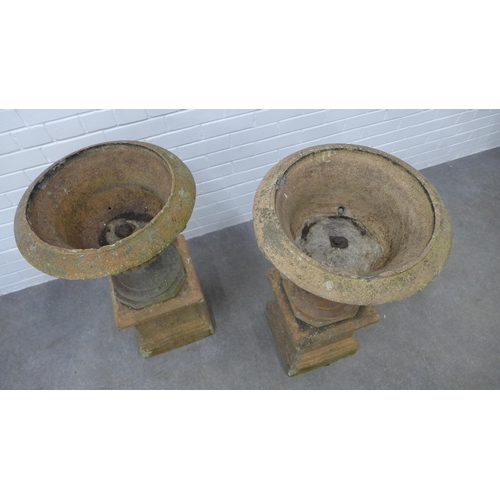 282 - Pair of garden urns, on stands. (one is A/F) 87 x 49cm. (2)