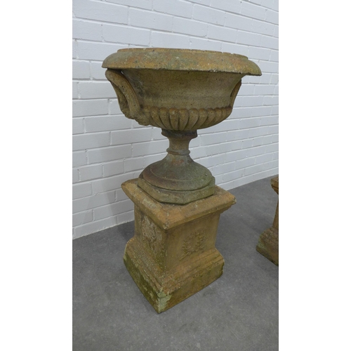 282 - Pair of garden urns, on stands. (one is A/F) 87 x 49cm. (2)