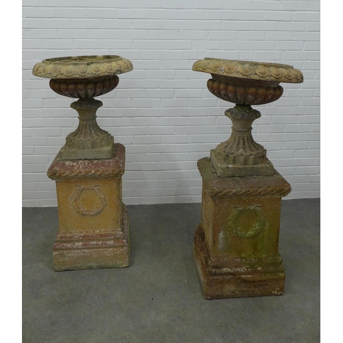 283 - Pair of large garden urns on stands. (one is A/F) 123 x 58cm. (2)