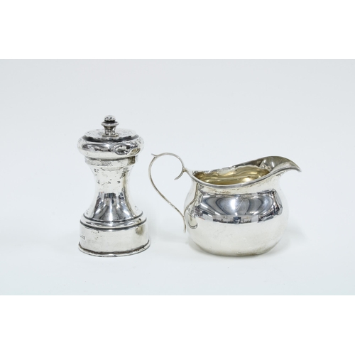 35 - George V silver cream jug, Birmingham 1911 and an Edwardian silver pepper grinder, Chester 1904 (2)