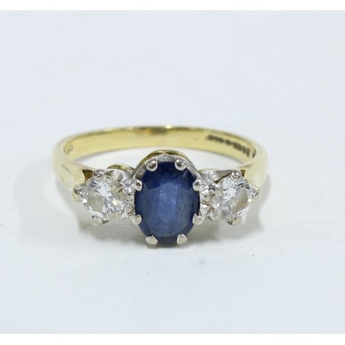 39 - Sapphire and diamond three stone ring, the central oval cut sapphire of approx. 0.75ct flanked by tw... 