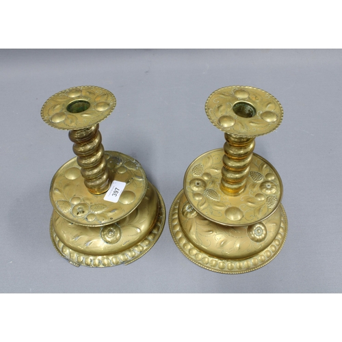 397 - A pair of unusual brass candlesticks, with spiral stems and fruit embossed drip trays, 24cm tall (2)