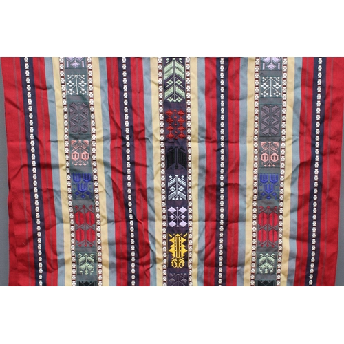 399 - Embroidered runner,  fringed ends, 120 x 240cm and a pair of brass candlesticks, (3)