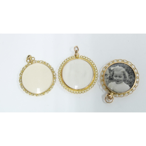 42 - Three 9ct gold lockets, circular, double sided and glazed, with suspension loops, 3.5cm diameter (3)