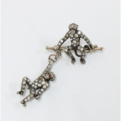 47 - Late 19th / early 20th century double monkey trapeze brooch, each monkey pave set with paste stones,... 