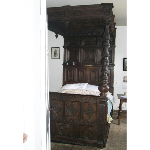 254 - Oak tester bed, triple inlaid panelled back and carved lozenge panelled canopy. 250 x 154 x 220cm. (... 