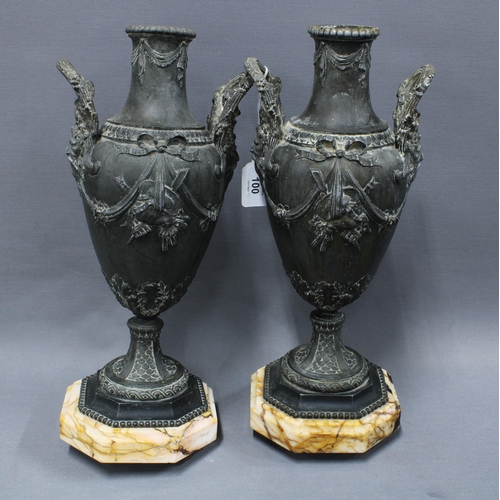 100 - A pair of classical style metal vases, twin handled with coloured hardstone bases, on gilded feet (o... 