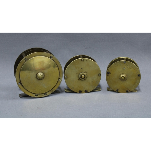 110 - Large brass salmon fishing reel and two smaller brass trout fishing reels, one signed to the backpla... 