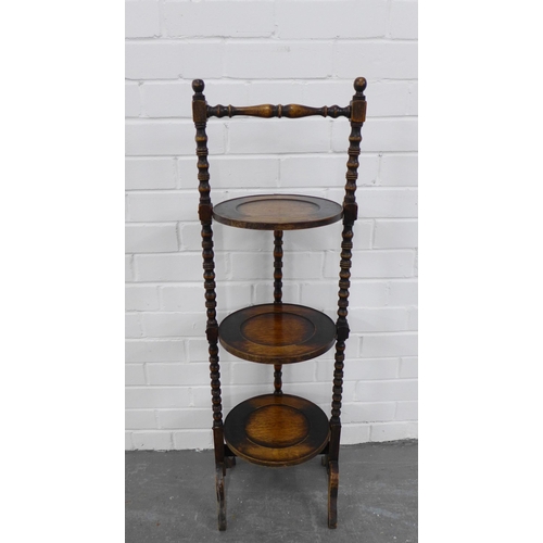 204 - An oak three tier cake stand. 99 x 31cm.