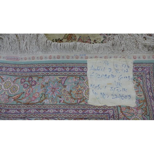 209 - Silk prayer rug, the ivory field with birds, vases and flowers, with stylised spandrels, signed. 170... 