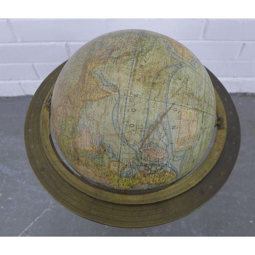 212 - Terrestrial table globe, within a brass gimbal and raised on an ebonised stand, 50 x 35cm.