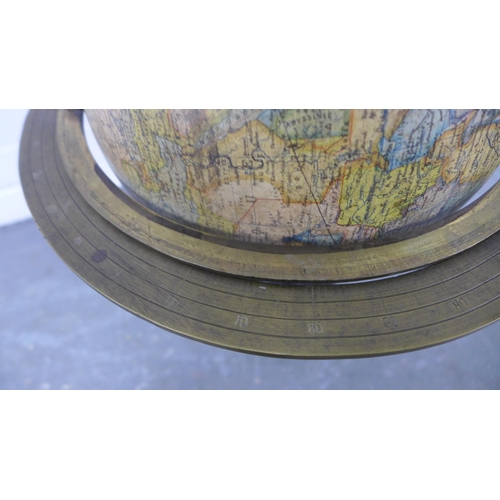 212 - Terrestrial table globe, within a brass gimbal and raised on an ebonised stand, 50 x 35cm.