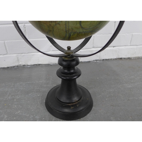 212 - Terrestrial table globe, within a brass gimbal and raised on an ebonised stand, 50 x 35cm.