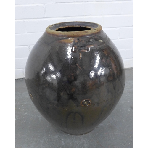 213 - Large Chinese brown glazed wine pot, in a basket. 41cm.