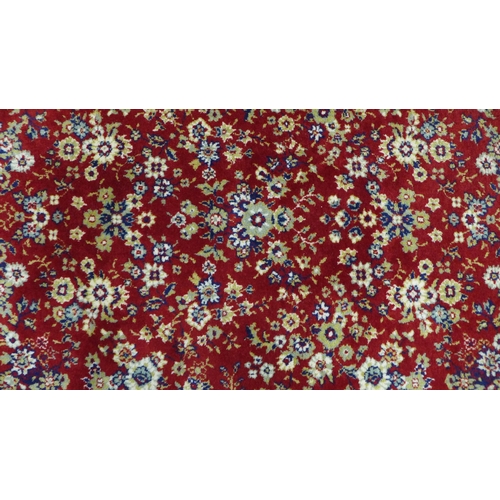 216 - Belgian wool rug, red foliate field. 232 x 172cm.