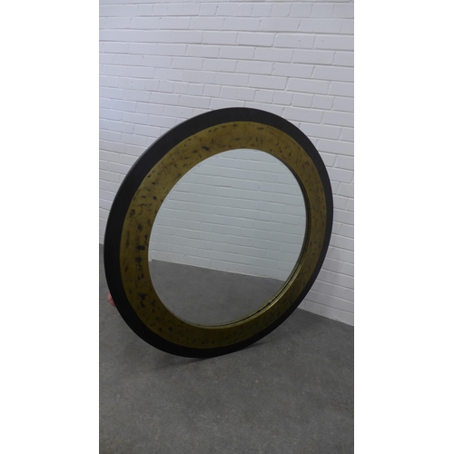 230 - Contemporary circular wall mirror with an ebonised and gilt frame, 109cm