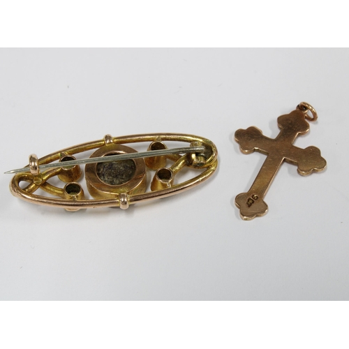 24 - 9ct rose gold crucifix and a yellow metal peridot brooch (2)