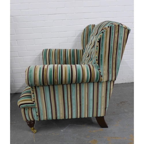 261 - Contemporary buttonback armchair with striped upholstery, on mahogany legs with brass caps and casto... 