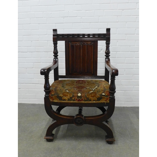 270 - Savonarola style chair top rail with dentil frieze and a linen fold back, open arms with floral upho... 