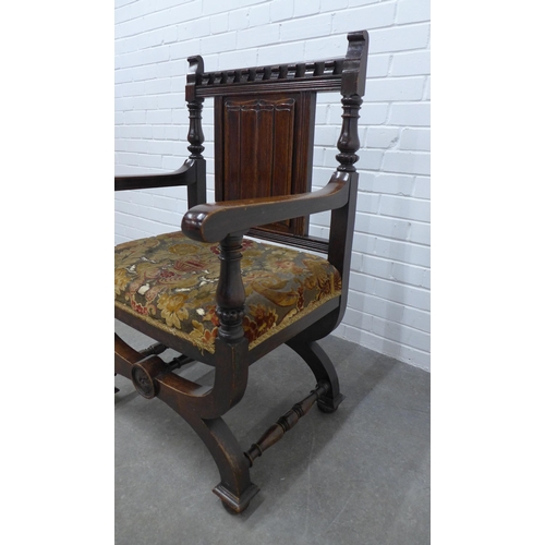 270 - Savonarola style chair top rail with dentil frieze and a linen fold back, open arms with floral upho... 