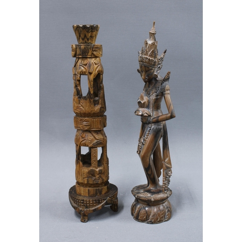 306 - Carved wooden totem style figure with detachable top, a wooden shovel and two Eastern carved wood fi... 