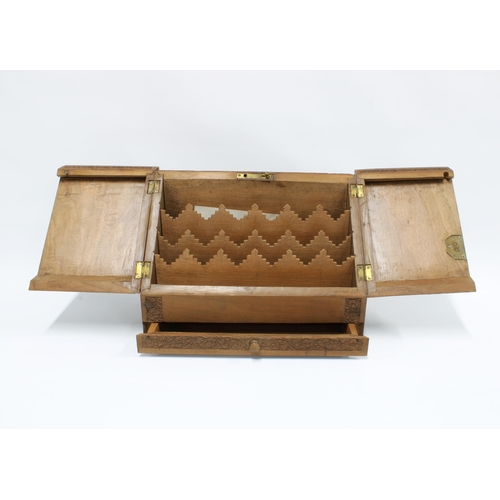 343 - Eastern carved hardwood stationary box, with two sloping doors, fitted interior and single long draw... 