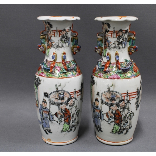 356 - A pair of Chinese Canton vases with dragons and temple lions, painted with scholar and other figures... 