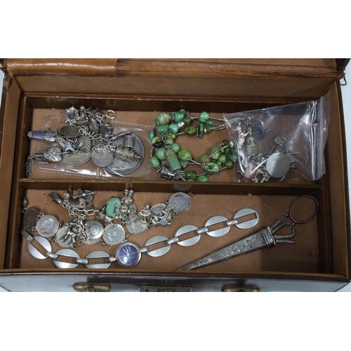 4 - Vintage brown leather jewellery box containing silver and white metal jewellery to include charm bra... 