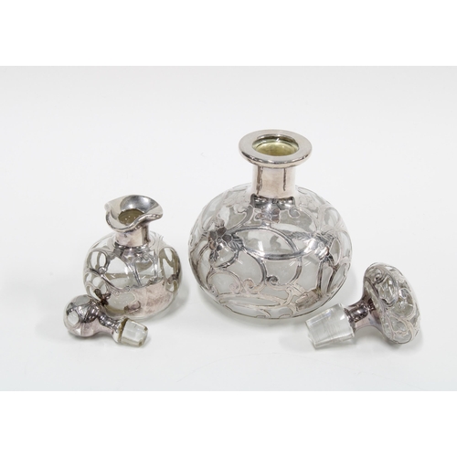 63 - Two silver overlaid glass scent bottles with stoppers, 12 & 8 cm (2)