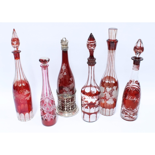 66 - Six various Bohemian ruby flashed glass decanters with stoppers to include one for whisky and one wi... 