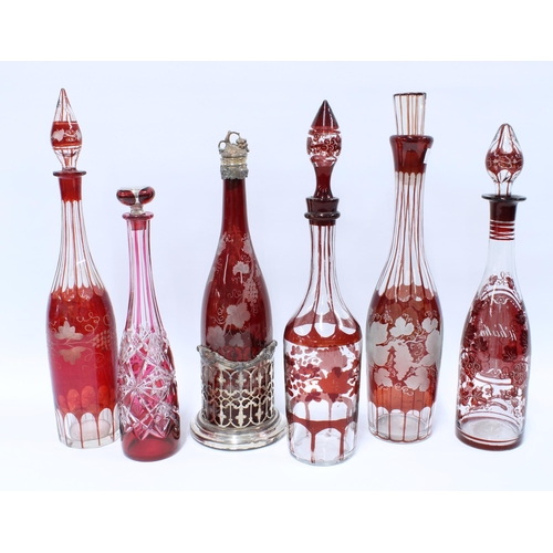 66 - Six various Bohemian ruby flashed glass decanters with stoppers to include one for whisky and one wi... 