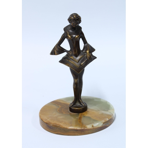 75 - Art Deco style bronze patinated metal figure of a girl in stylistic dress, on a hardstone base, 15cm