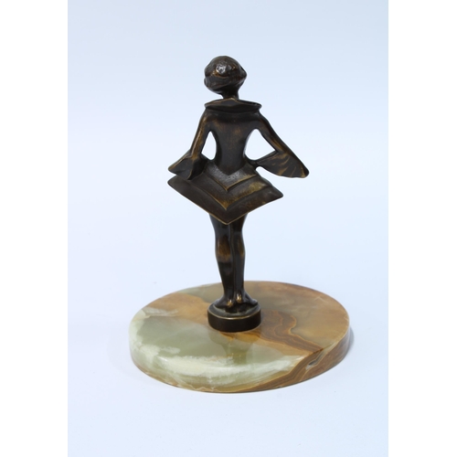 75 - Art Deco style bronze patinated metal figure of a girl in stylistic dress, on a hardstone base, 15cm