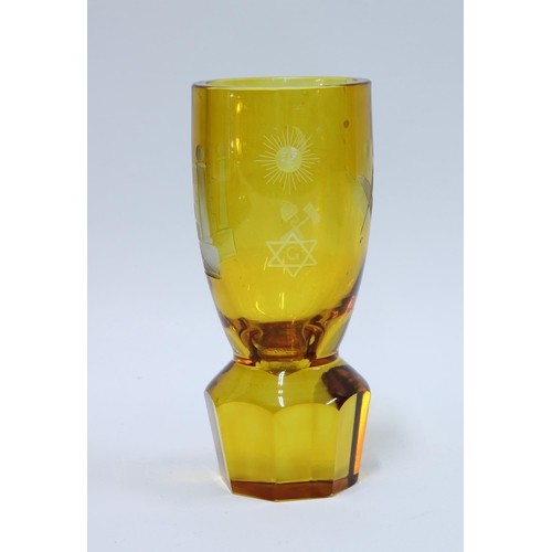 82 - Masonic firing glass, amber glass with etched square and compass on a circular facet cut base, 14cm