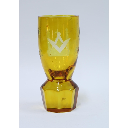 82 - Masonic firing glass, amber glass with etched square and compass on a circular facet cut base, 14cm