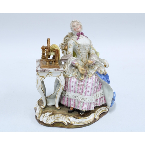 92 - 19th century porcelain figure of a woman sat in a high back chair beside a spinning wheel, blue cros... 