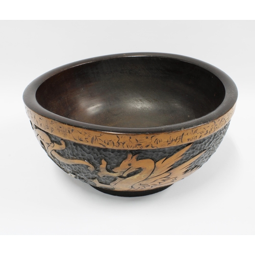 111 - Early 20th century Dragon pokerwork fruit bowl, 30cm diameter