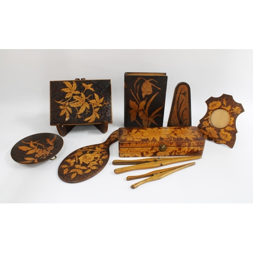 122 - A collection of Art Nouveau pokerwork items to include photograph frames, glove stretchers and a glo... 