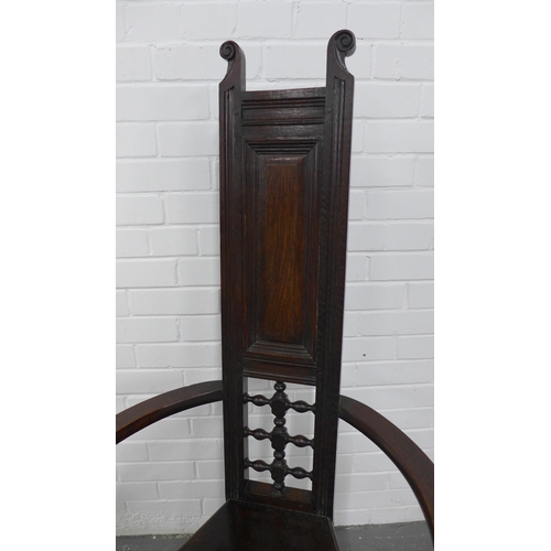 290 - Manner of Liberty & Co, London oak Shakespeare chair, with a panelled and pierced back,  triangular ... 