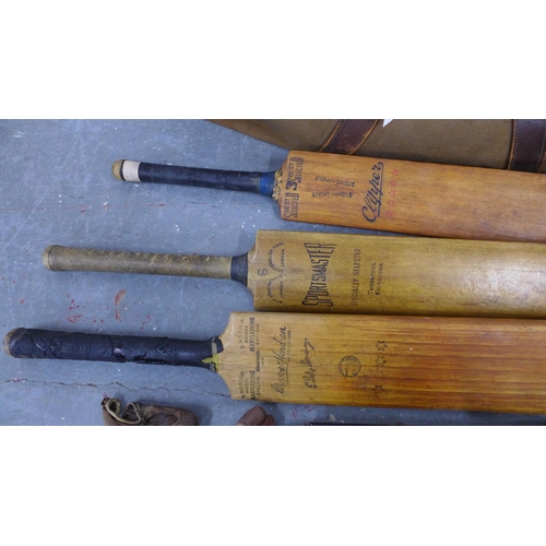 297 - A vintage collection of cricket related items, includes three bats, a ball, shoes and books, sewnwor... 