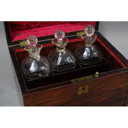 307 - 19th century rosewood and brass inlaid decanter box, the hinged lid opening to reveal a set of three... 