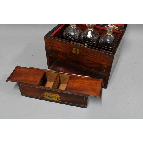 307 - 19th century rosewood and brass inlaid decanter box, the hinged lid opening to reveal a set of three... 