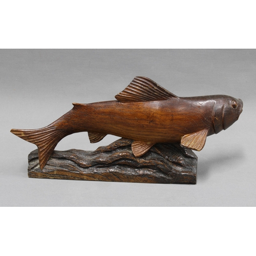 311 - Carved wooden fish figure. 40cm wide.