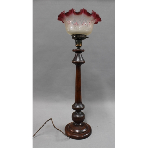 313 - Mahogany table lamp with red frilled glass shade. 61cm.