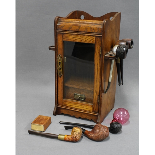 337 - An Edwardian oak and glass pipe cabinet, 32cm,  together with a collection of briar pipes to include... 