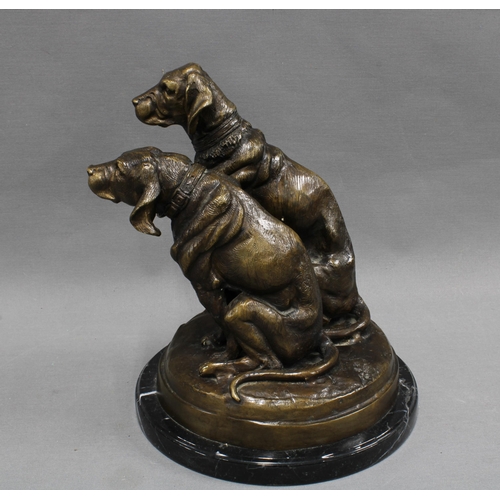 368 - Bronze study of two dogs raised  on a polished black hardstone base, apparently unsigned  27cm high