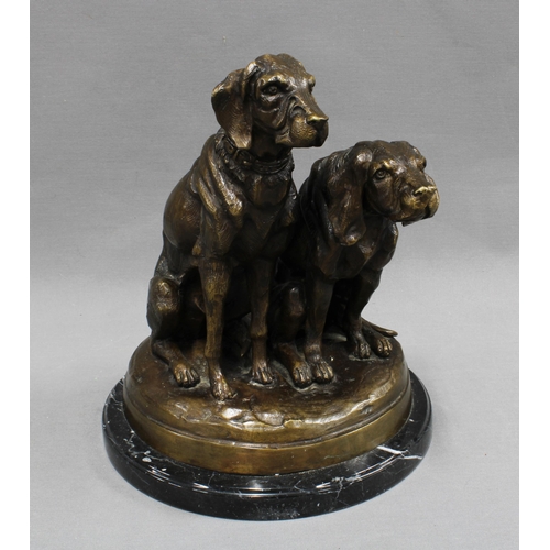 368 - Bronze study of two dogs raised  on a polished black hardstone base, apparently unsigned  27cm high