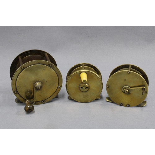 378 - Large brass salmon fishing reel and two smaller brass trout fishing reels, one signed to the backpla... 