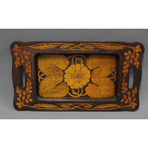 379 - Collection of pokerwork to include an Art Nouveau tray with lily pad leaves, 47cm long, a smaller tr... 