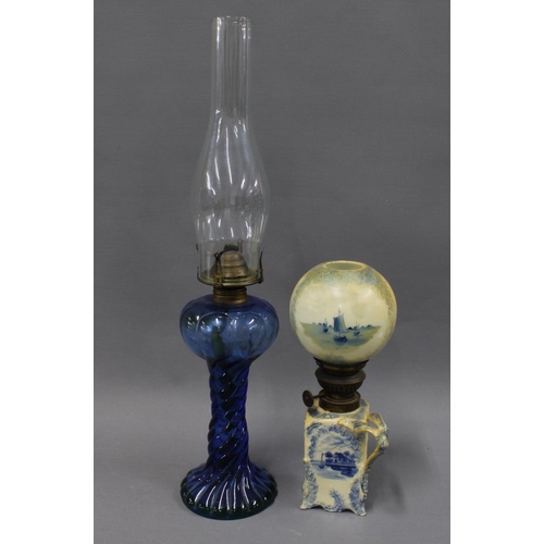 380 - Blue glass oil lamp with glass funnel and a Delft blue and white lamp with globular shade, (2)